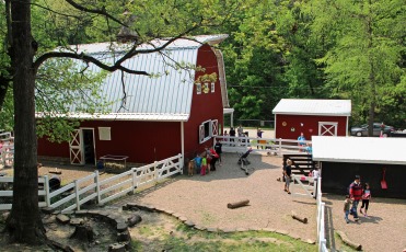 The big red barn and farmyard at Old MacDonalds Farm in Bever Park